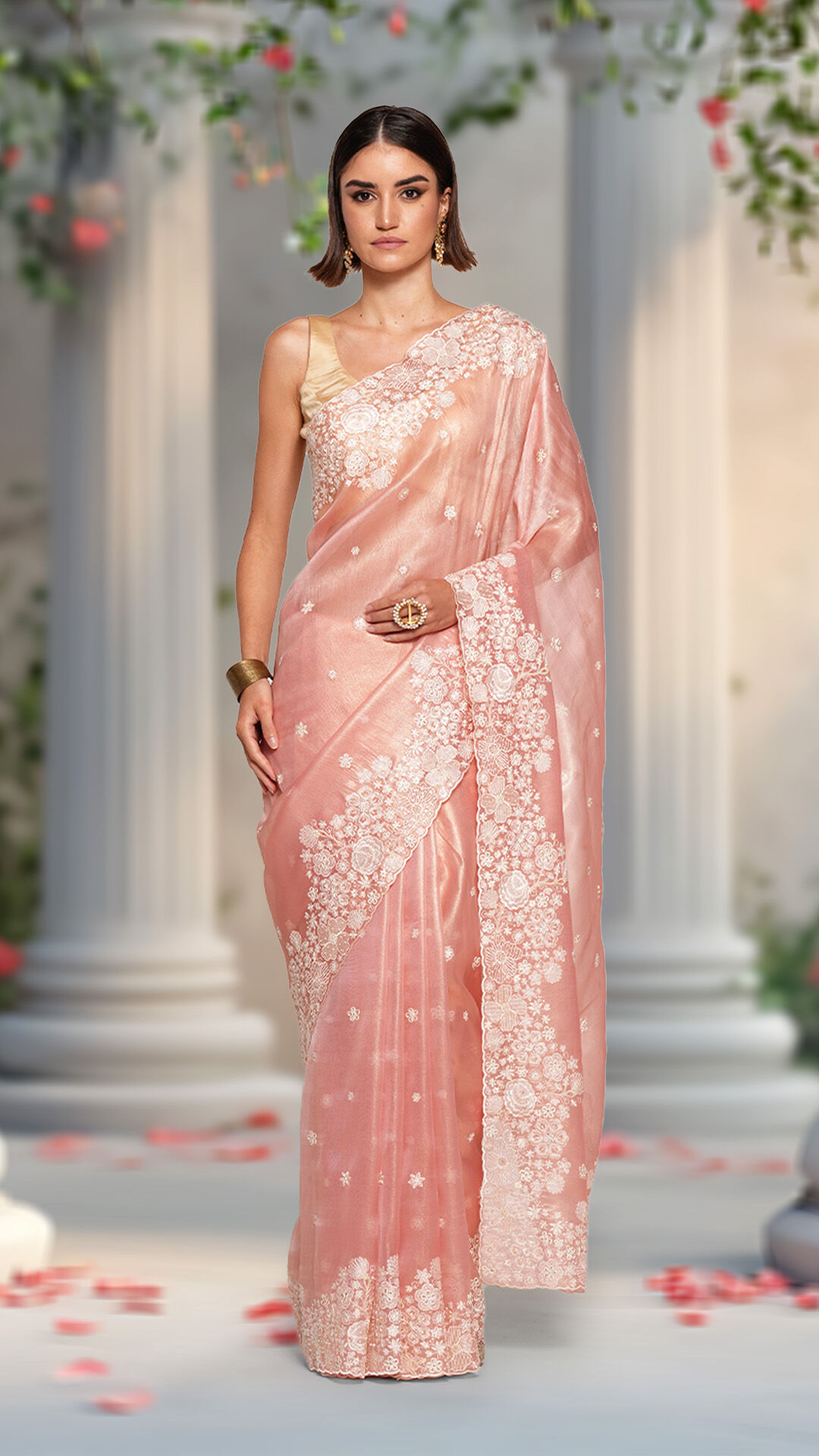 Woman in a floral saree stands in a garden setting, ideal for garden weddings. Perfect for bridal planning and wedding attire inspiration.